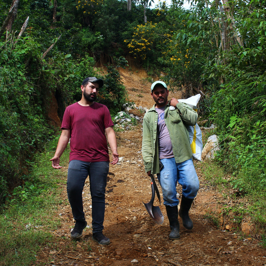 Benjamín Paz Muñoz walking with a colleague at La Orquidea in Santa Barbara, Honduras